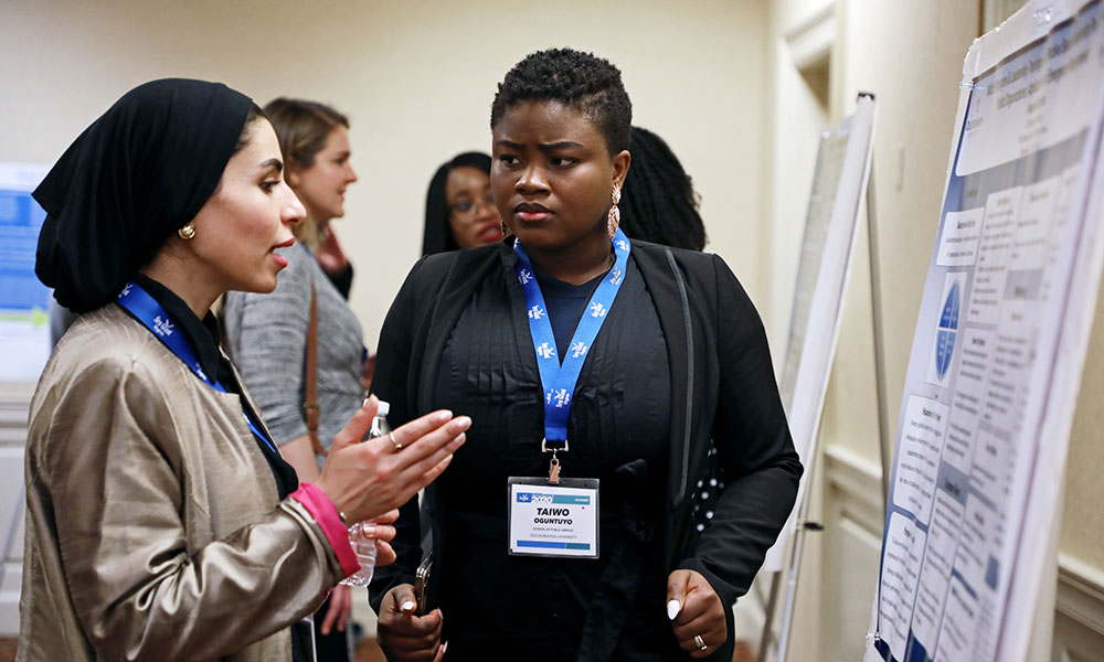 Student presenting a poster at a conference